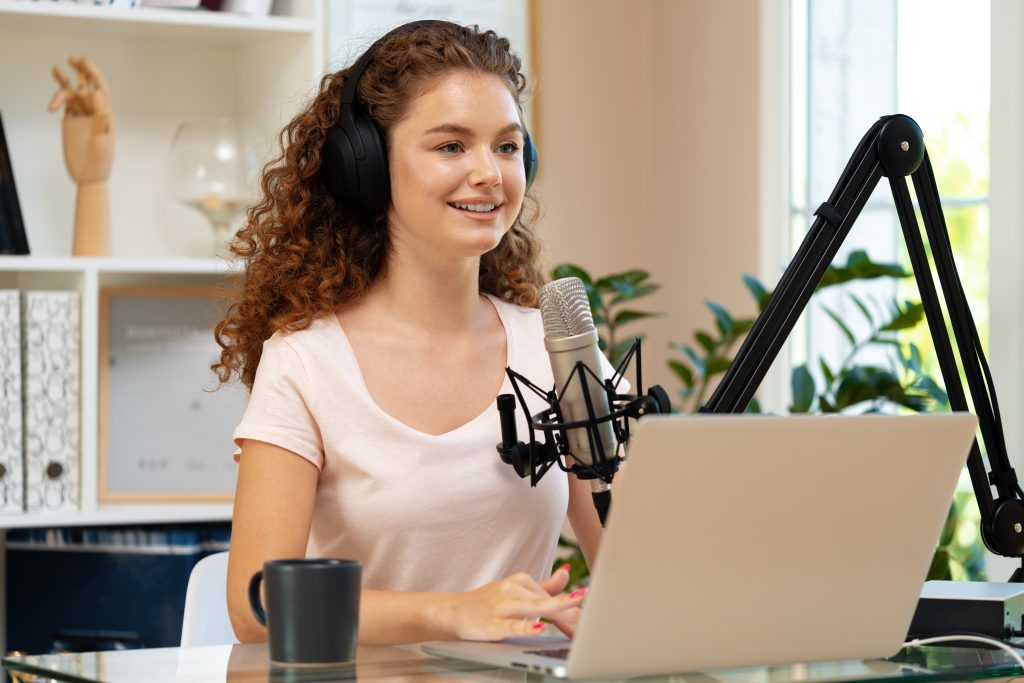 Woman looking at a laptop and recording a video tutorial with a microphone close-up.
Record your Screen to Create Videos Tutorials